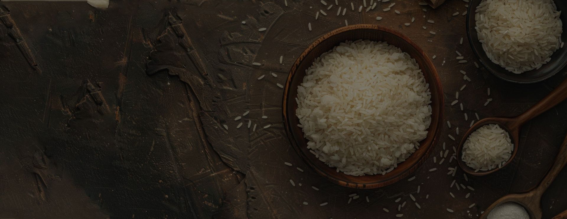 Premium quality white rice grains in wooden bowls on a rustic background for Lalbaba Rice banner